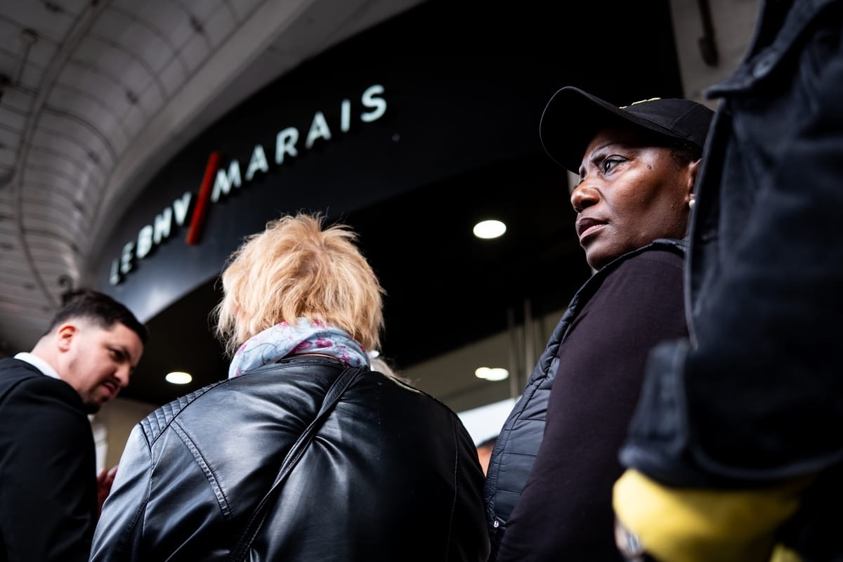 Devant l’entrée du BHV Marais à Paris, les premiers clients entrent dans le magasin le jour de l’ouverture de la boutique Shein. Une femme de profil au premier plan, l’enseigne LE BHV MARAIS