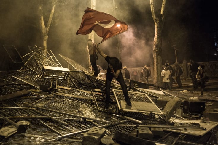 A demonstrator reacts to teargas fired by Turkish police during a protest in the neighborhood Besiktas in Istanbul, Turkey, June 1, 2013. Tens of thousands of people gathered to protest against the destruction of Gezi Park in central Istanbul and to voice general discontent with the government's policies. The park is virtually the only remaining green space in the city's center and it is planned to give way for the construction of a mall.