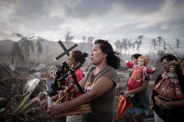 Survivors of Super Typhoon Haiyan march during a religious procession in Tolosa on the eastern Philippine island of Leyte on November 18, 2013 over one week after Super Typhoon Haiyan devastated the area.  The United Nations estimates that 13 million people were affected by Super Typhoon Haiyan with around 1.9 million losing their homes.     AFP PHOTO / Philippe LopezPHILIPPE LOPEZ/AFP/Getty Images
